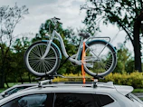 a bicycle on top of a car in a parking lot