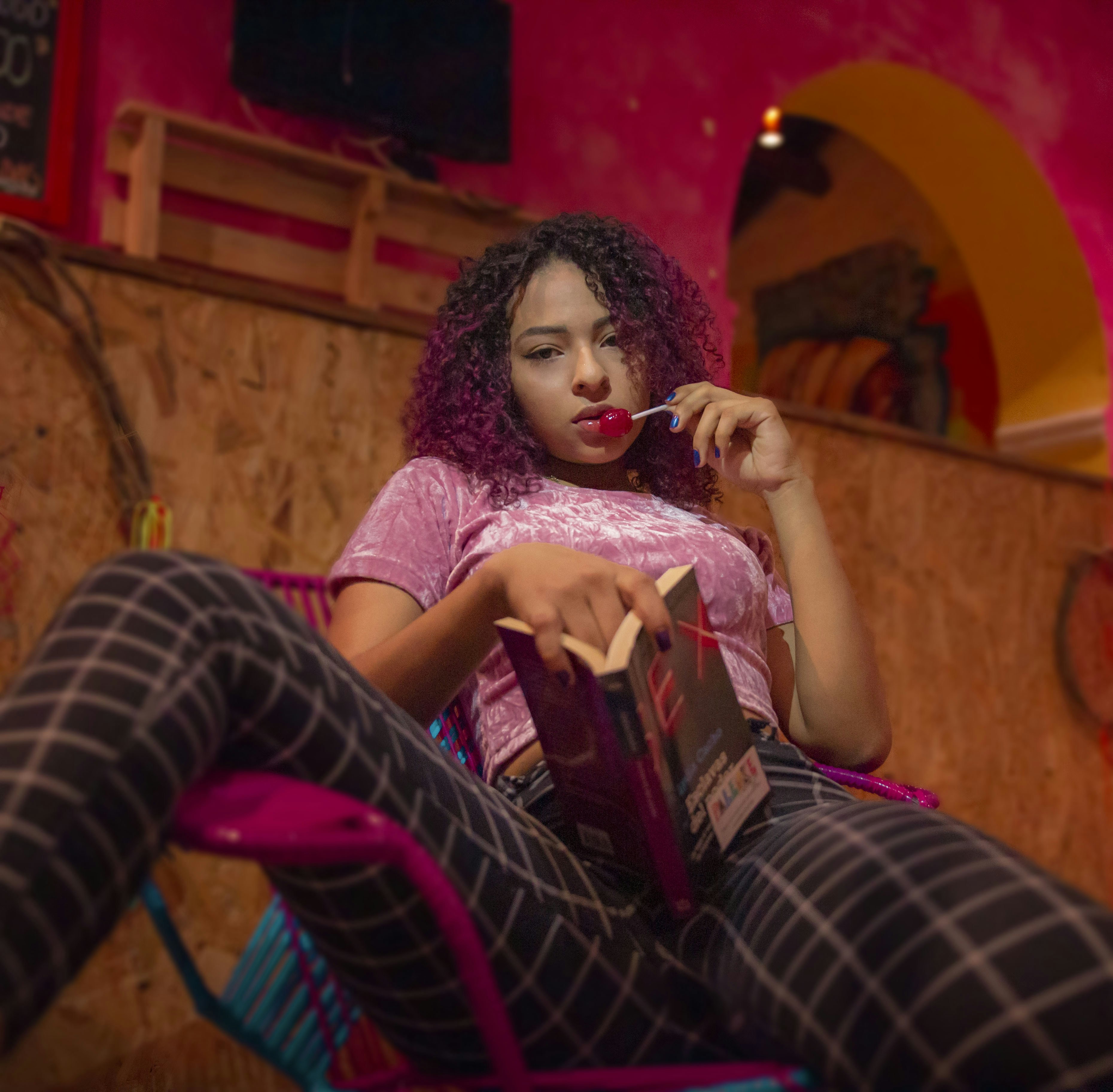 a woman sitting in a chair with a book in her hand