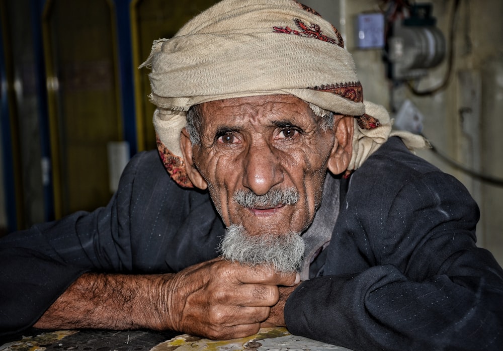 an old man with a white beard and a white turban