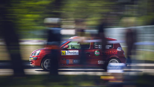 Dynamic image of a race car speeding on the track.