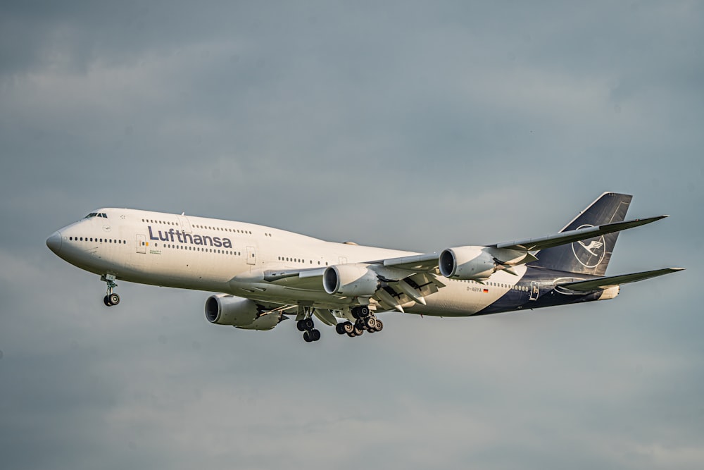 a large jetliner flying through a cloudy sky