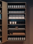 A neatly arranged shelf displaying various household essentials.