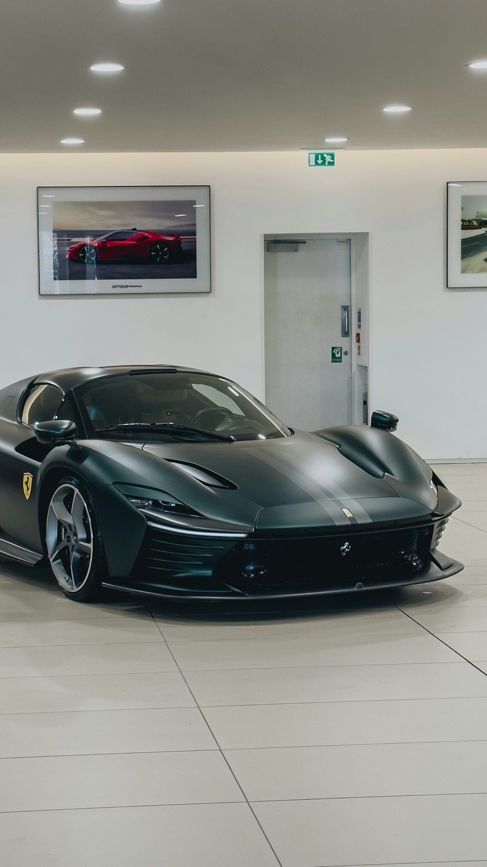 a black sports car is parked in a showroom