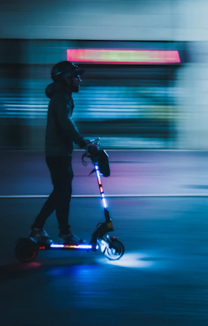 Electric scooter gliding smoothly through a bustling city street at sunset.