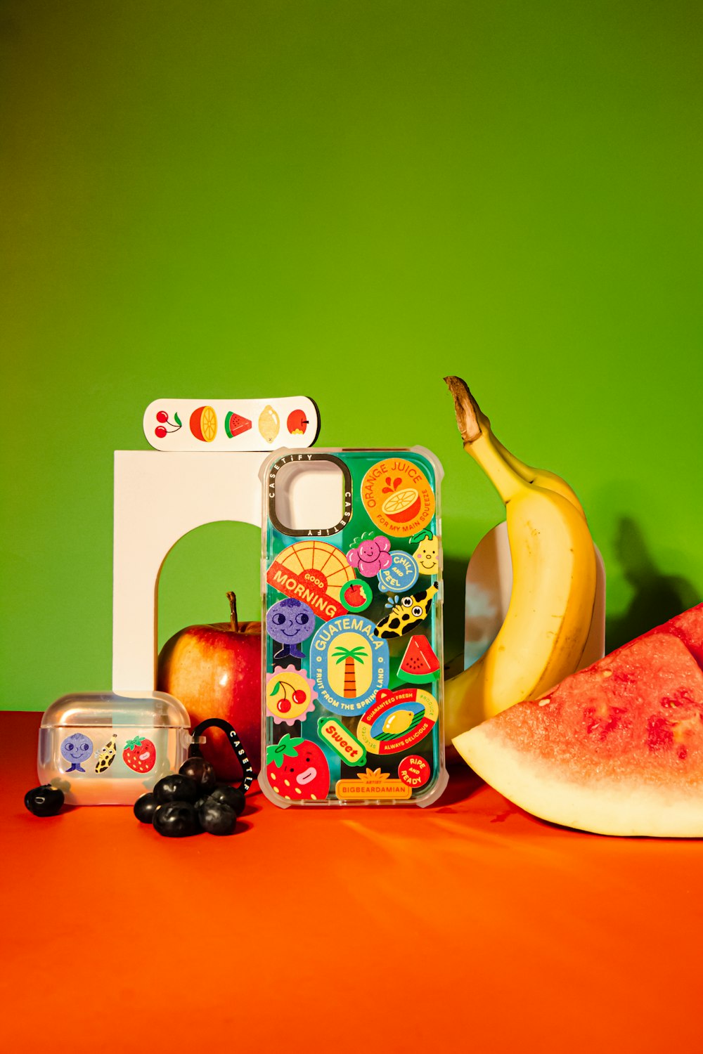 a banana, watermelon, and other fruit on a table