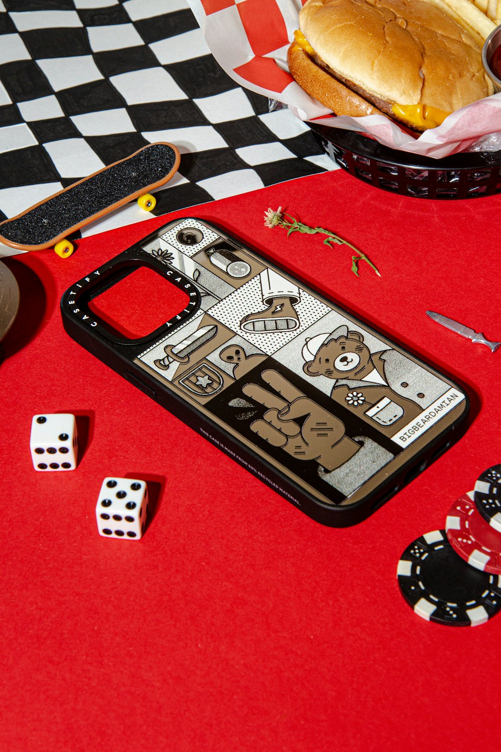 a red table topped with dices and a sandwich