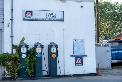 a couple of parking meters sitting next to a building