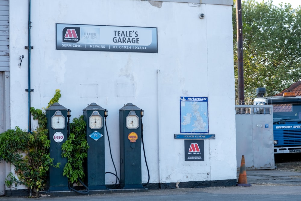 a couple of parking meters sitting next to a building