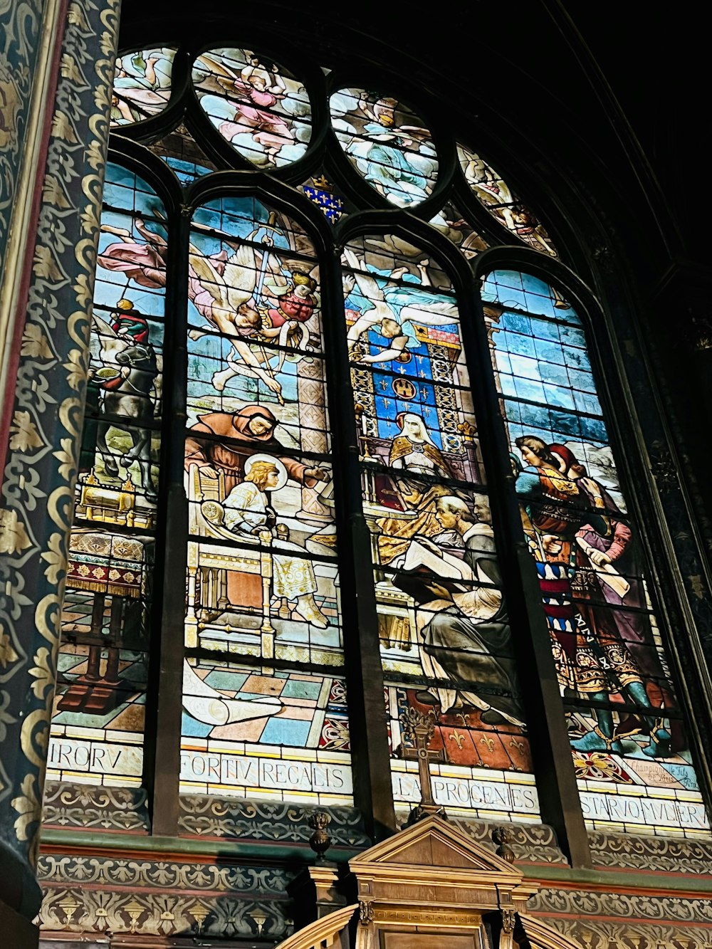 a large stained glass window in a church