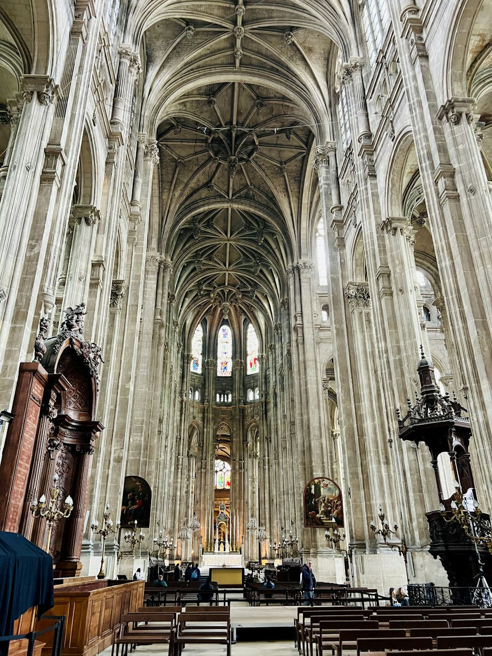 a large cathedral with pews and stained glass windows