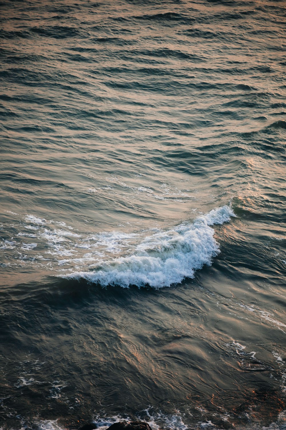 a person riding a surfboard on a wave in the ocean