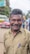 A middle-aged man sharing a positive review with joy.