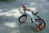 A colorful children's bike being handled gently by a Velosafe courier.