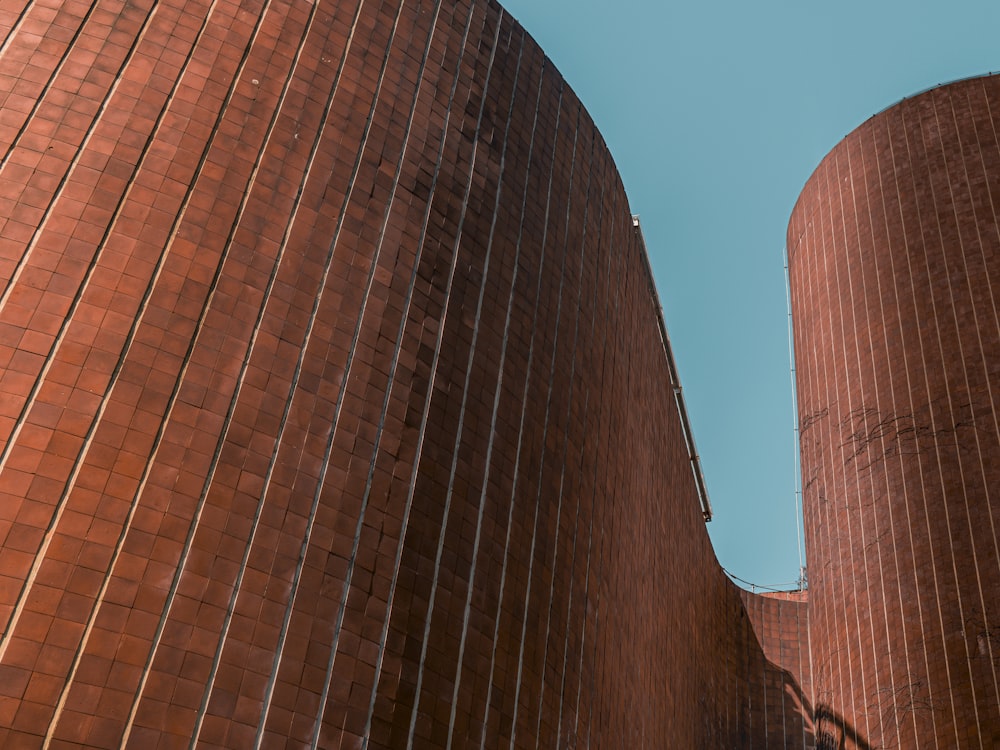 two large brick silos against a blue sky