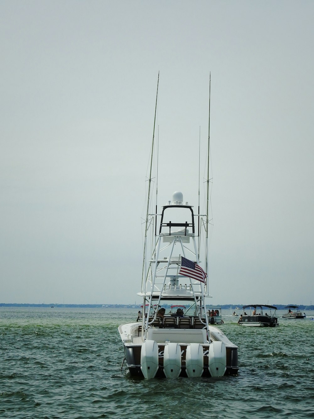 a white boat floating on top of a body of water