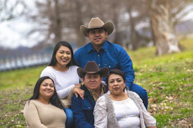 a group of people that are sitting in the grass