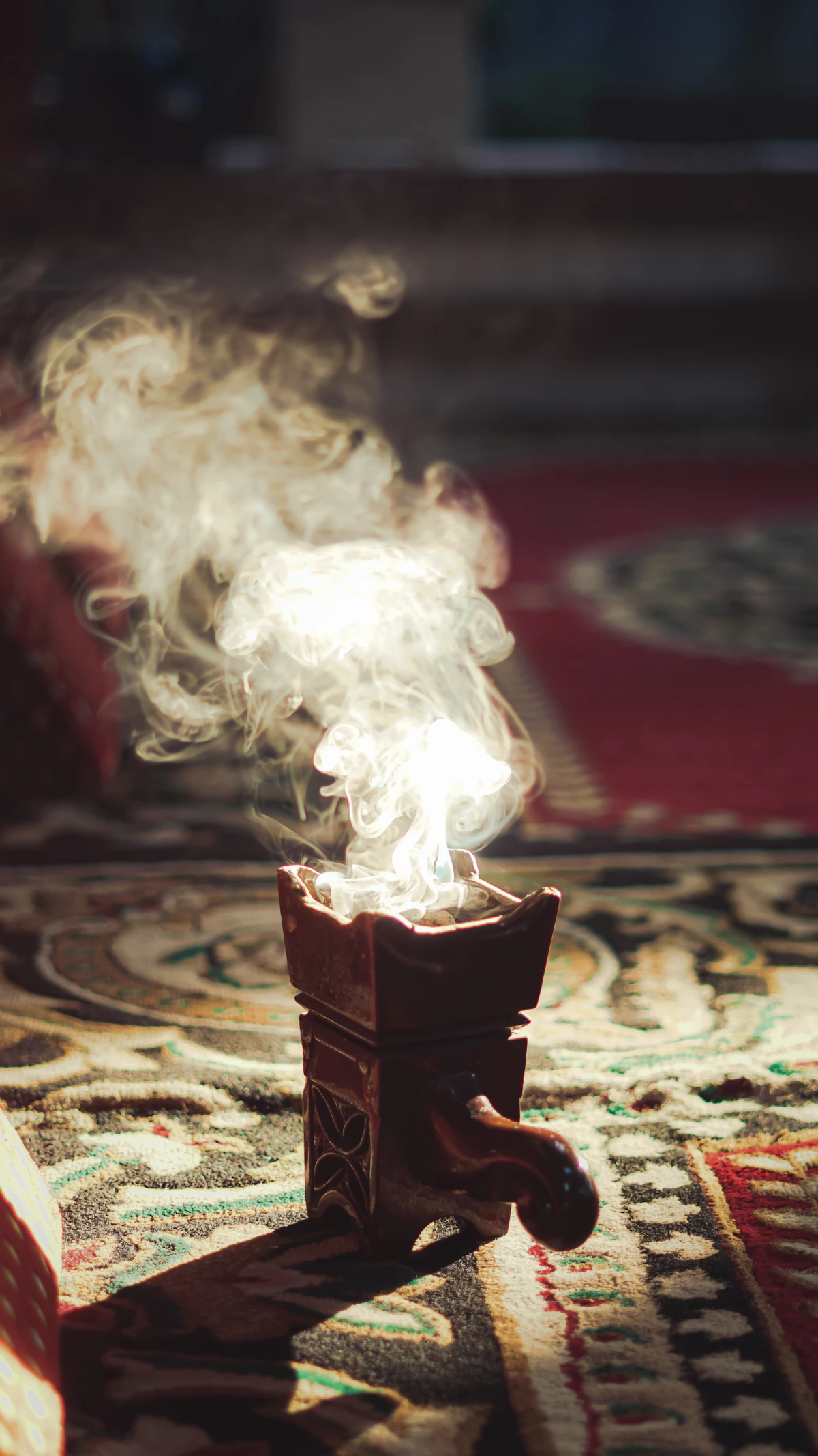Oud and traditional incense burning with atmospheric smoke