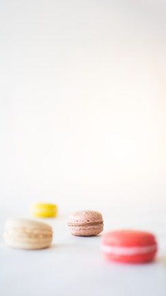 Colorful macarons arranged in neat rows with soft natural light.