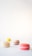 A close-up of colorful macarons displayed on a delicate white plate, set against a minimal backdrop.