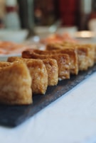 Fresh tofu blocks neatly packaged and ready for delivery in eco-friendly wrapping.