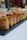 Close-up of a plate with golden tofu cubes garnished with herbs on a rustic wooden table.