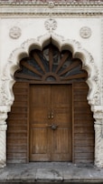 An artistic wooden door featuring unique carvings.