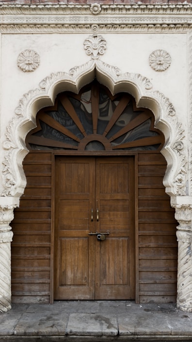 A beautifully crafted wooden front door with intricate carvings set in a cozy home entrance.