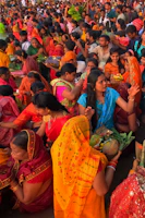 A vibrant gathering of devotees during a Hindu cultural festival with traditional attire and decorations.