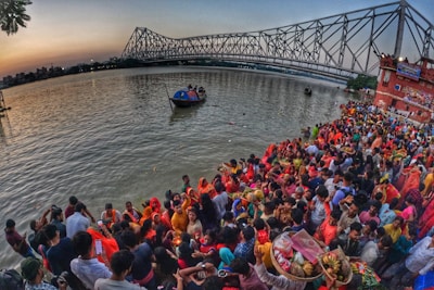 Colorful crowds and decorated boats along the Godavari River banks during Pushkaram.