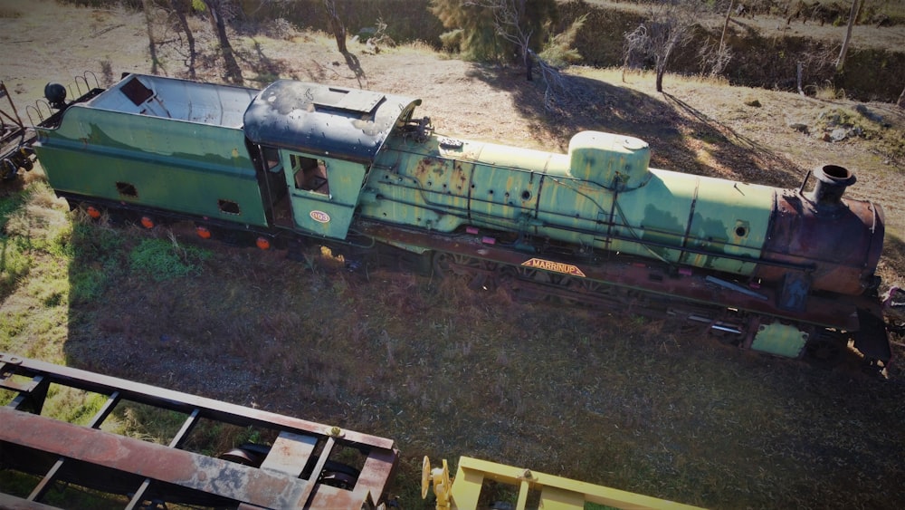 an old train car sitting in the middle of a field