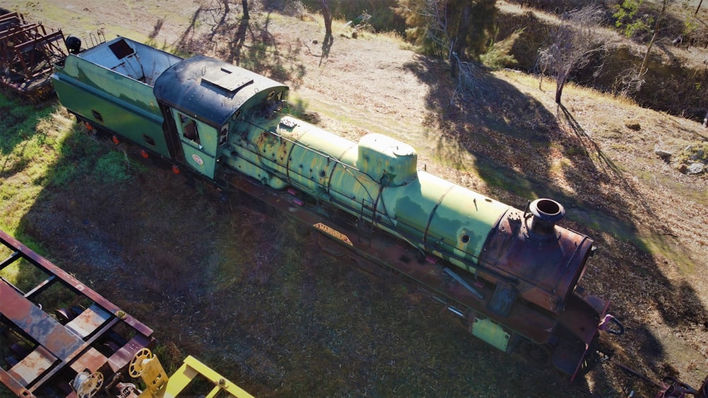 an old train is sitting in the middle of a field