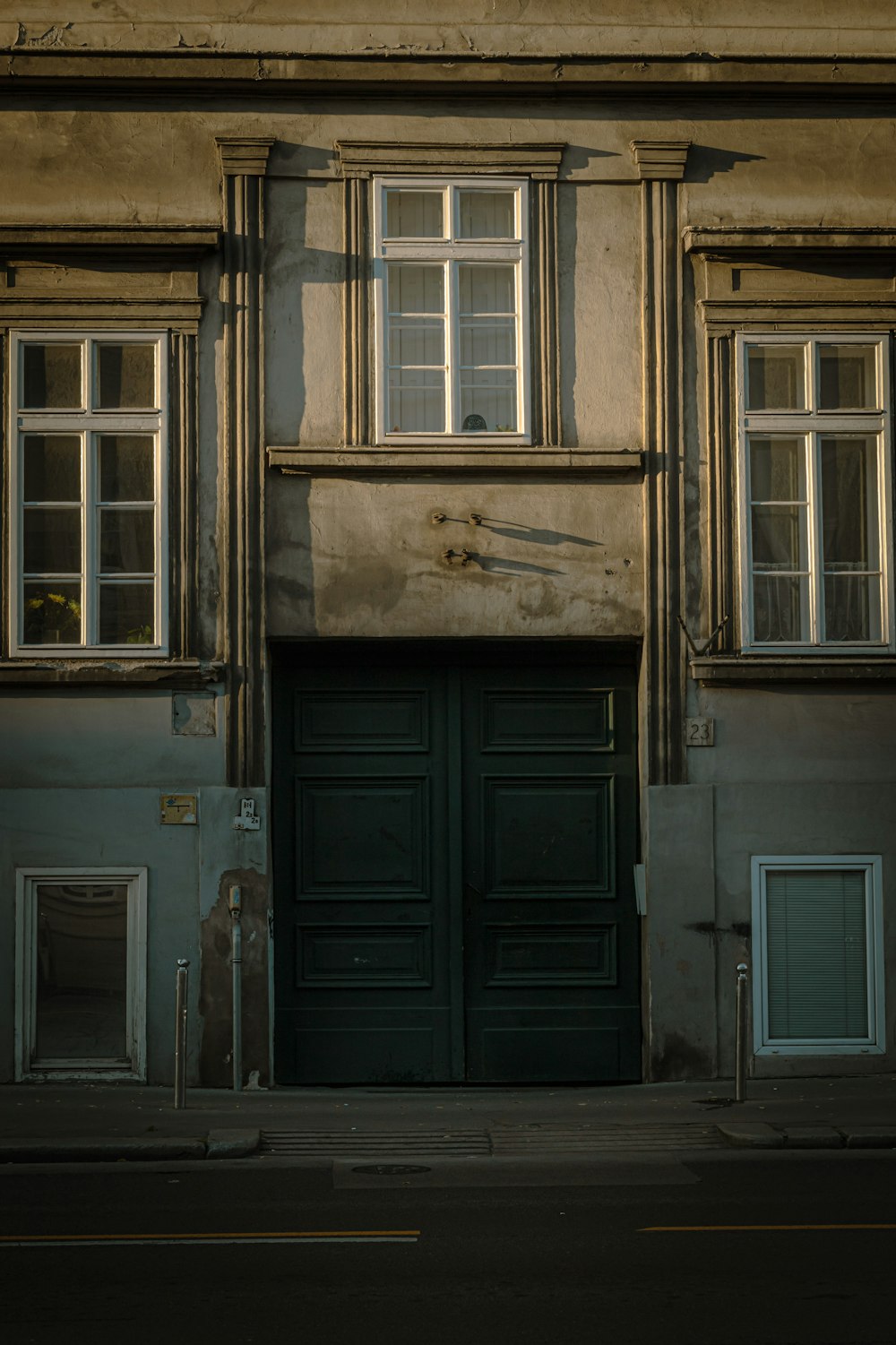 an old building with a green door and windows