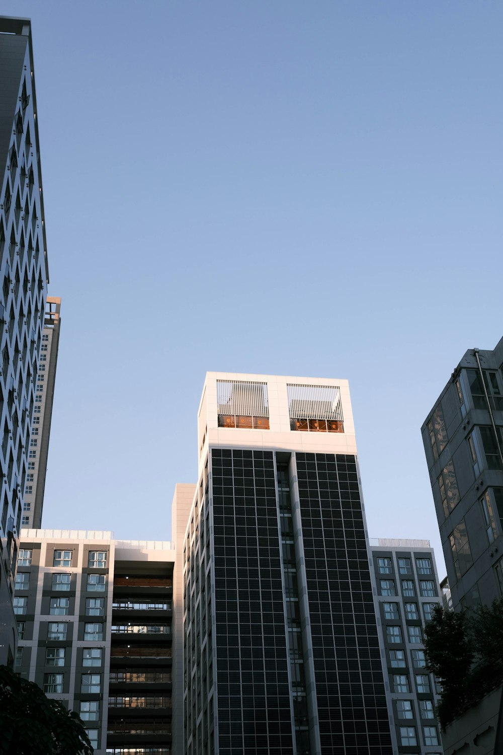 a couple of tall buildings sitting next to each other