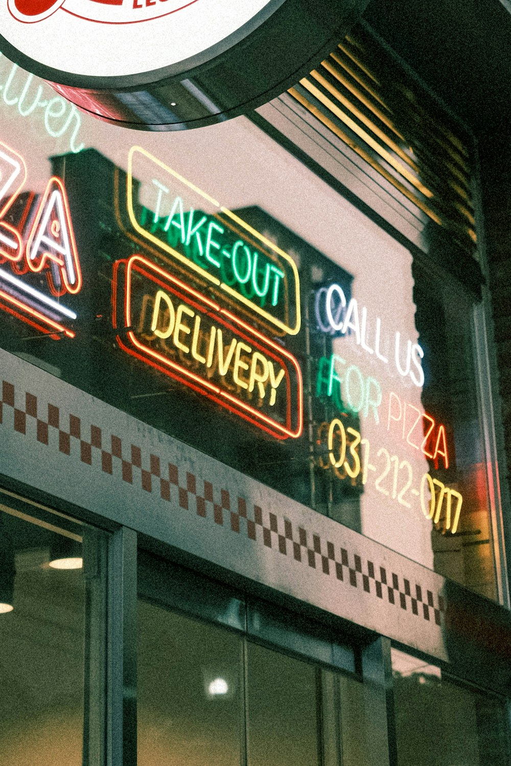a neon sign on the side of a restaurant