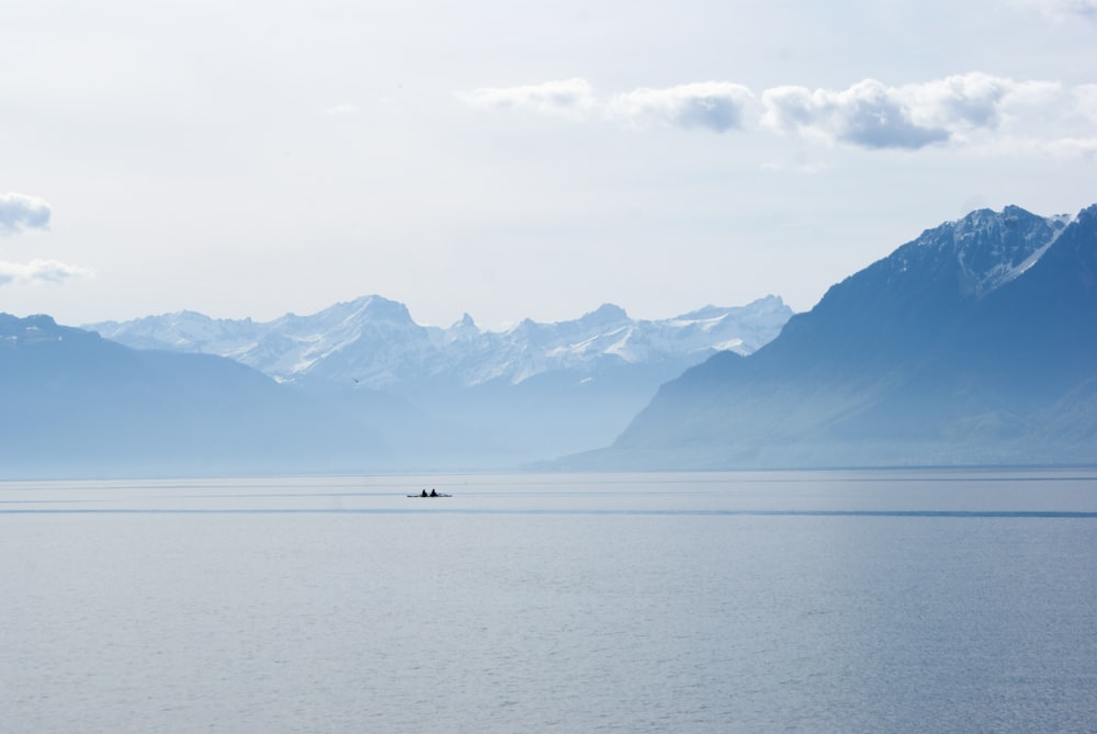 a lone boat in the middle of a large body of water