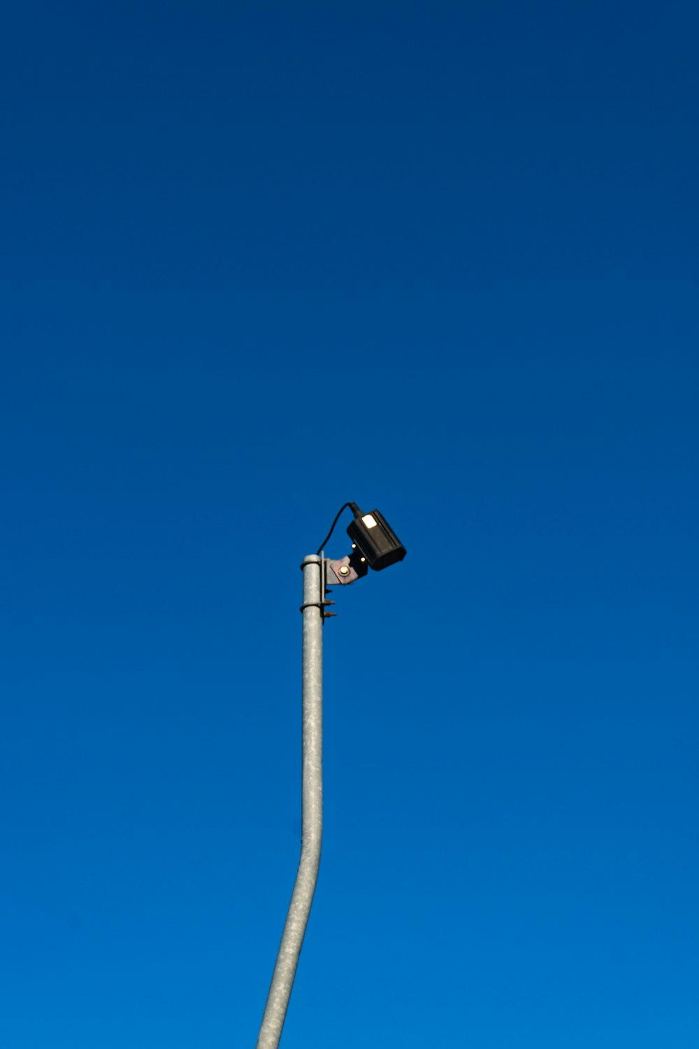 a street light with a blue sky in the background