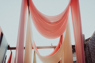 A serene setting with scarves flowing gently in the breeze.