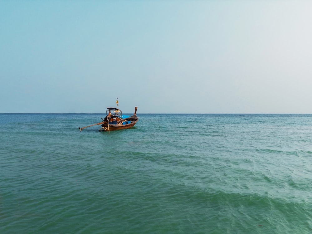 a small boat floating on top of a large body of water