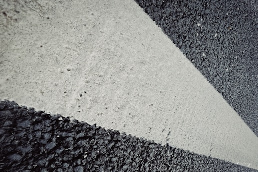 Close-up of pavement markings including directional arrows.