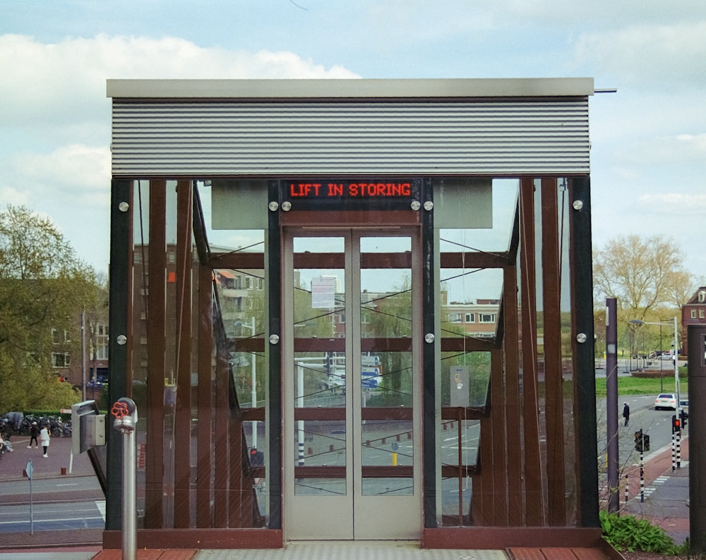 the entrance to a train station with a red sign on the door