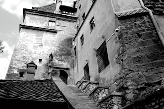 A black and white photo of an old building with textured walls.