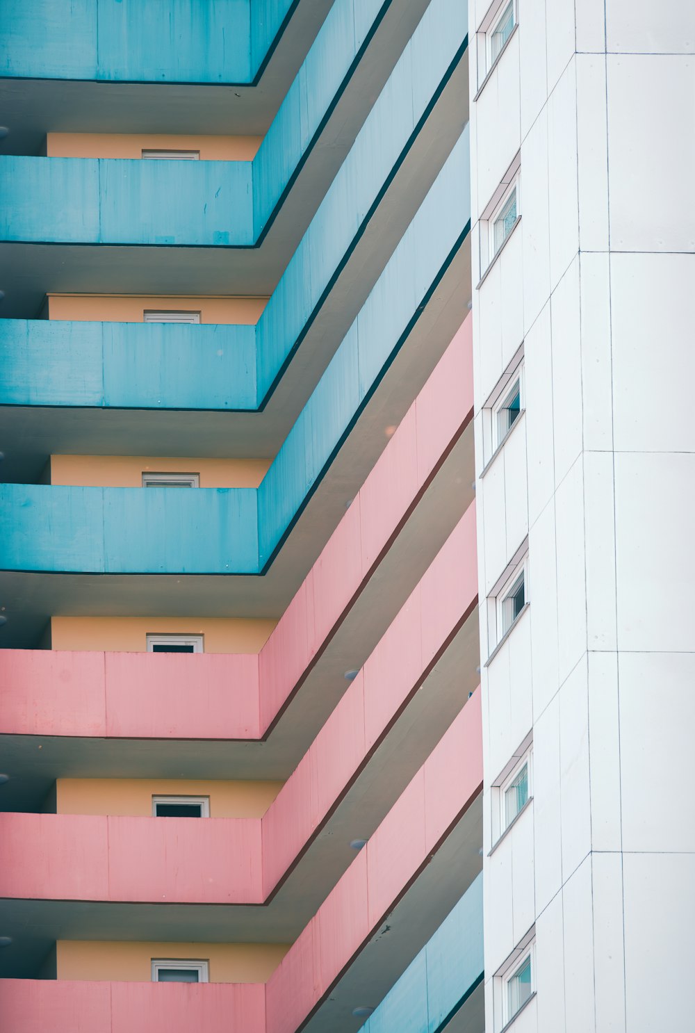 a multicolored building with balconies and windows