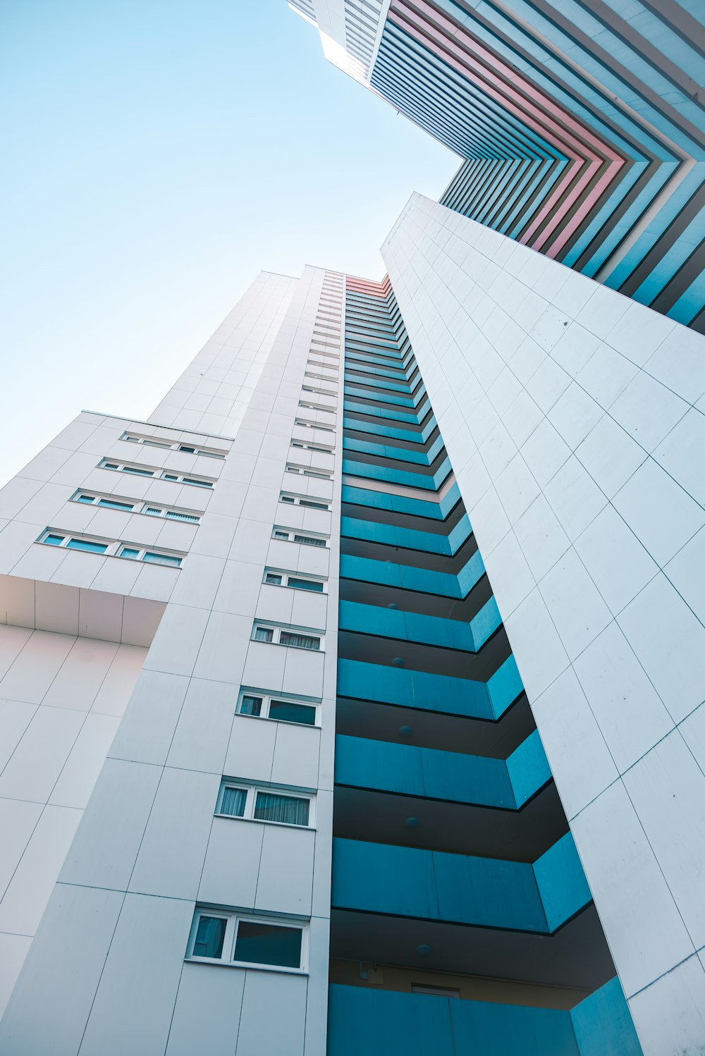 a tall white building with a sky background