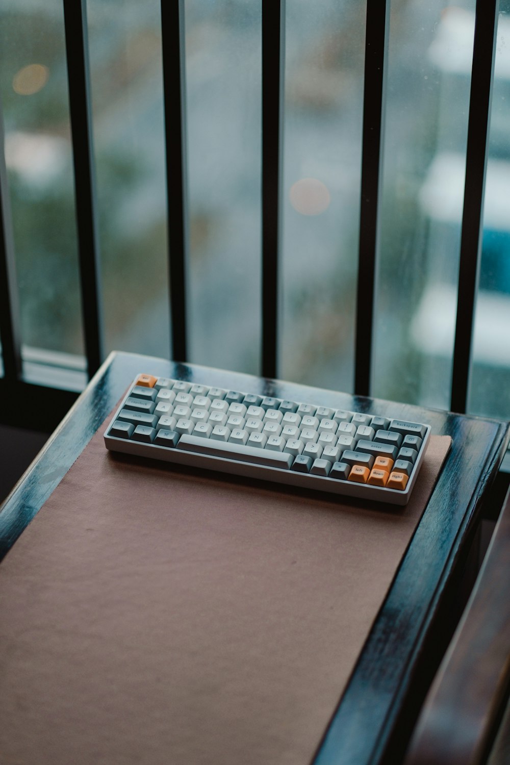 a keyboard sitting on top of a wooden table