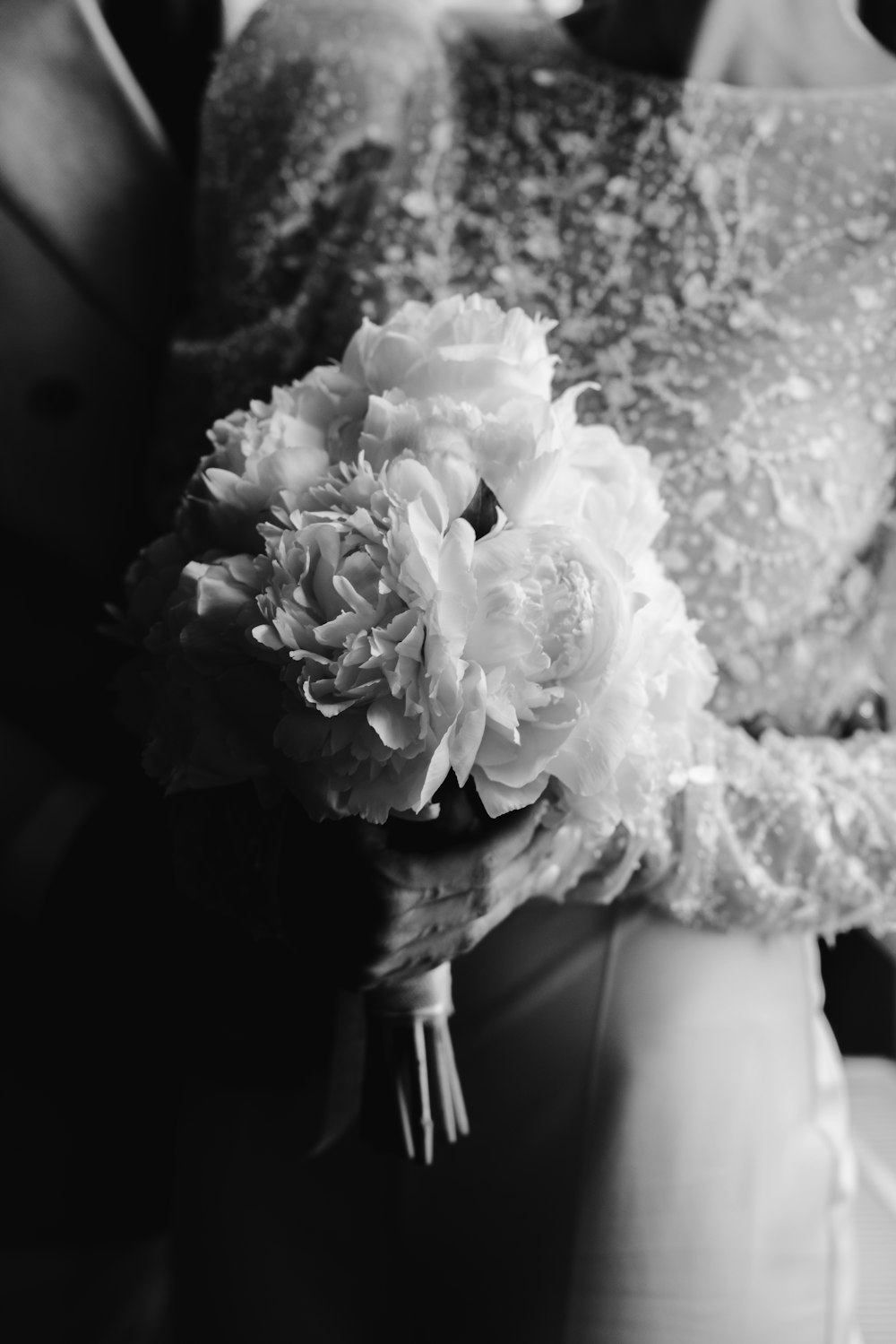 a bride holding a bouquet of flowers in her hand