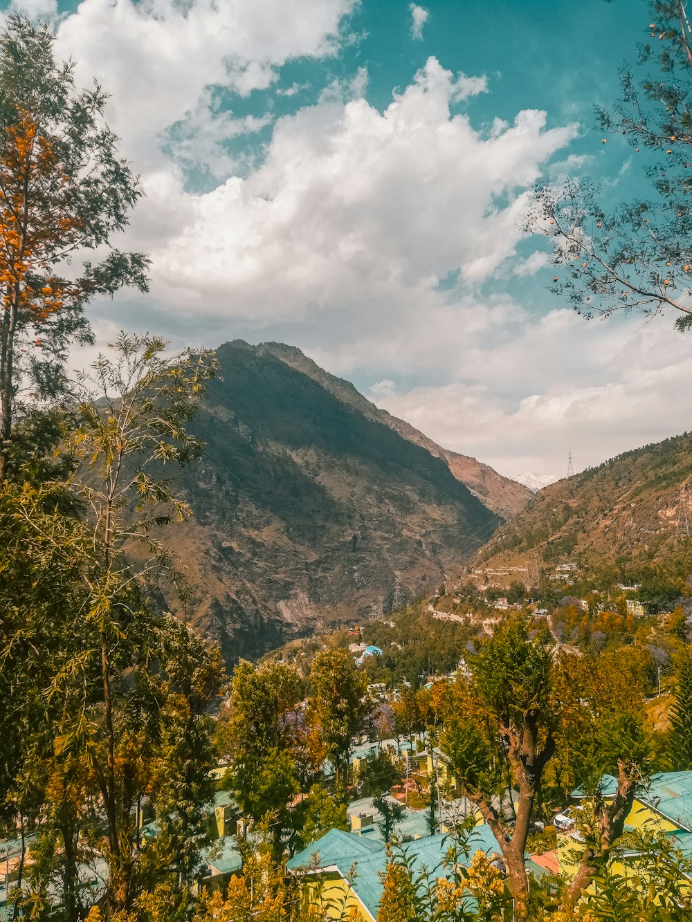 a scenic view of a valley with mountains in the background