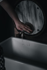 A handyman repairing a faucet in a cozy kitchen.