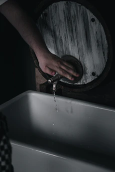A friendly handyman fixing a leaky faucet in a cozy kitchen.