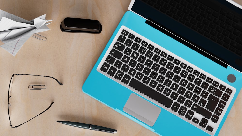 a laptop computer sitting on top of a wooden desk