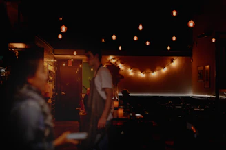 A warm interaction between hospitality staff and event guests under soft lighting, showcasing attentive service.